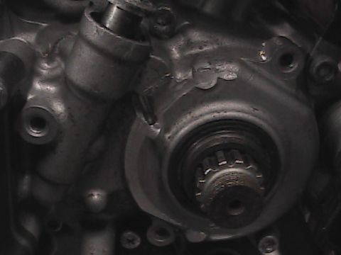2007 Yamaha YZ450F - A detailed view of a motorcycle engine component, a splined shaft and metallic casing.