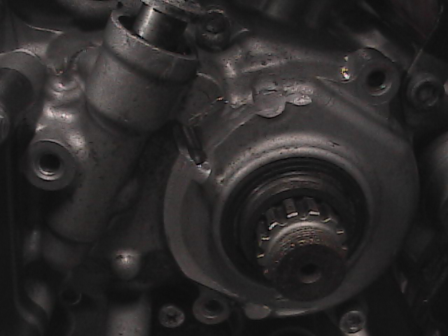 Close-up of motorcycle engine part with splined shaft