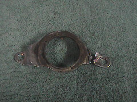 2007 Yamaha YZ450F - This is a damaged metal bracket, likely a motorcycle part, with a broken section.