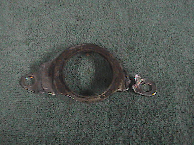 Damaged metal bracket with a circular opening and a broken piece
