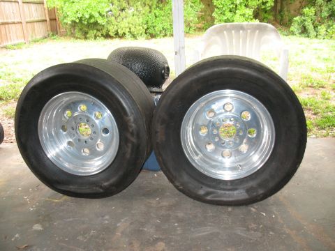 1985 Ford LTD Crown Victoria - Pair of drag slicks on polished aluminum wheels, likely for a performance vehicle.