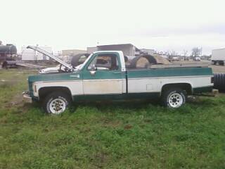 1979 Chevrolet Cheyenne - This 1973 Chevrolet C/K pickup truck is seen from the side with its hood open. The truck is green and white and parked in a grassy area.