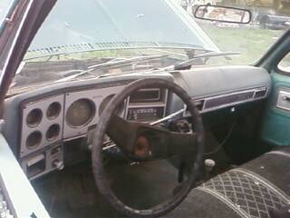 1979 Chevrolet Cheyenne - Interior view of a green Chevrolet pickup truck, showing the dashboard and steering wheel.