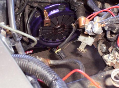 1995 Ford Probe - The image shows a close-up view of a vehicle's clutch assembly, with visible wiring and hoses.
