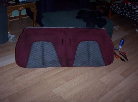 1995 Ford Probe - Car seat back with maroon upholstery and gray patterned inserts is shown on a wood floor.