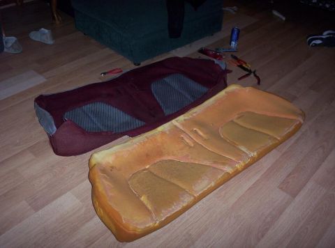 1995 Ford Probe - Car seat cushions and fabric are disassembled and laid out on the floor, possibly for reupholstering.