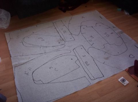 1995 Ford Probe - Carpet cutouts are laid out on a wooden floor, possibly for a custom interior project.