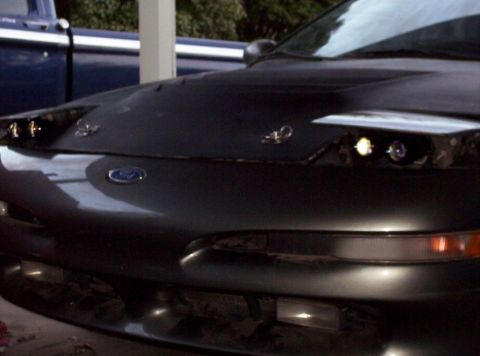 1995 Ford Probe - Front view of a 1995 Ford Probe, showing its hood and pop-up headlights.