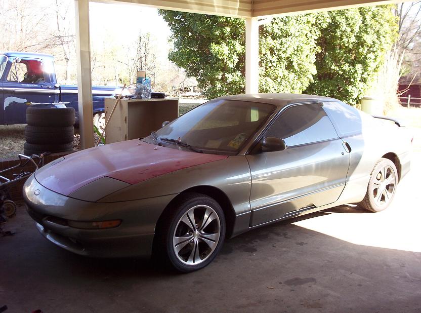 Gray 1995 Ford Probe with red hood, 3q-front view