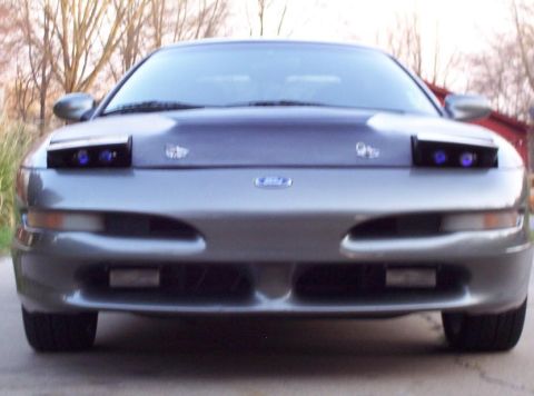 1995 Ford Probe - Front view of a gray 1995 Ford Probe, showing its pop-up headlights in the down position.