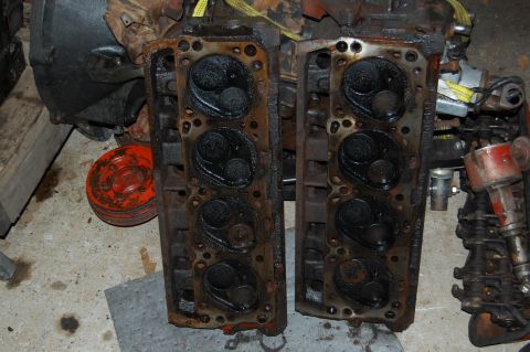 1994 Ford Bronco - Engine cylinder heads are shown in a close-up view, revealing their internal components and signs of wear.