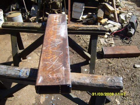 1989 Ford Bronco - Metal tube with chalk markings sits on sawhorses in a workshop setting.