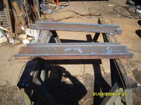 1989 Ford Bronco - Two metal frames are being fabricated on sawhorses, possibly for a vehicle winch mount.