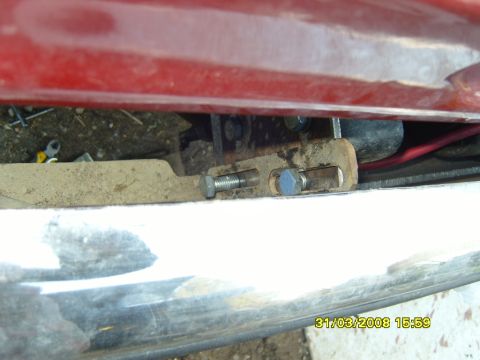 1989 Ford Bronco - Hardware for a winch mount is visible, attached to a red vehicle body.