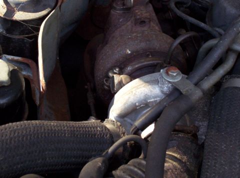 1995 Ford Probe - Close-up view of a vehicle's engine turbocharger, showing rusted components and various hoses.