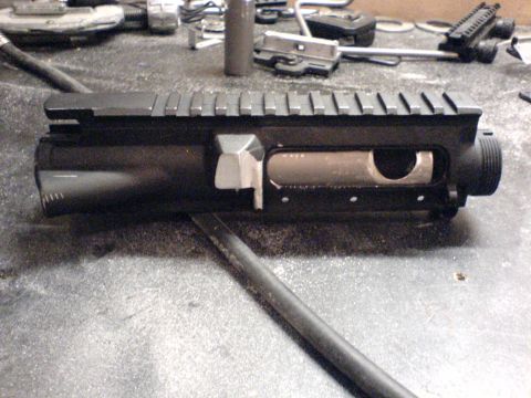 1985 Ford Bronco - AR-15 upper receiver shown on a workbench with various tools and parts.