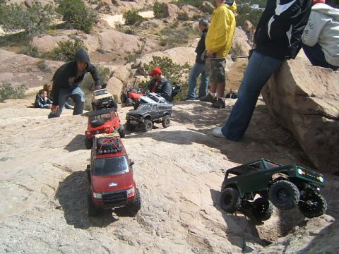 1988 Ford Bronco - RC rock crawlers navigate a challenging rocky landscape during an event.