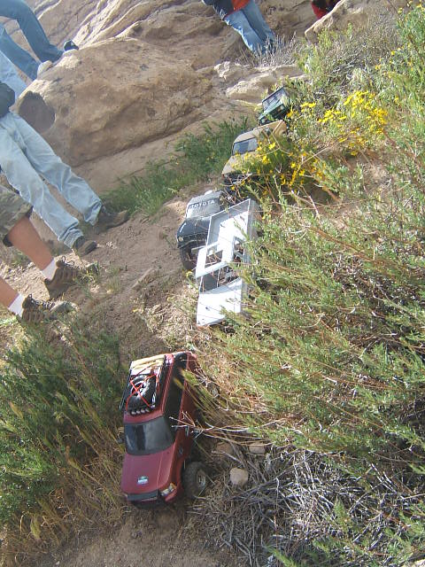 1988 Ford Bronco - RC crawlers navigate a challenging rocky terrain, with several vehicles lined up on the slope.