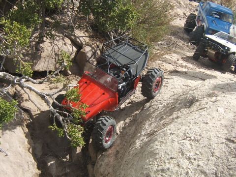 1988 Ford Bronco - Two remote control rock crawlers navigate a challenging rocky terrain.