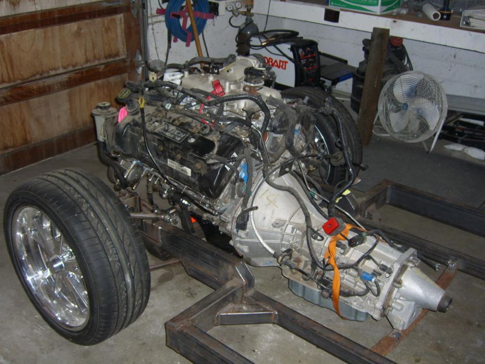 Ford modular V8 and automatic transmission installed on a custom fabricated frame in a garage