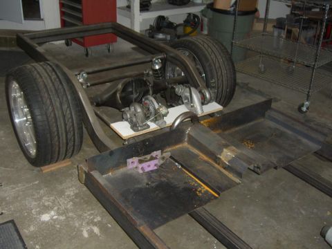 1964 Ford Ranchero - Custom car frame assembly with rear axle and turbochargers, likely for a project build.