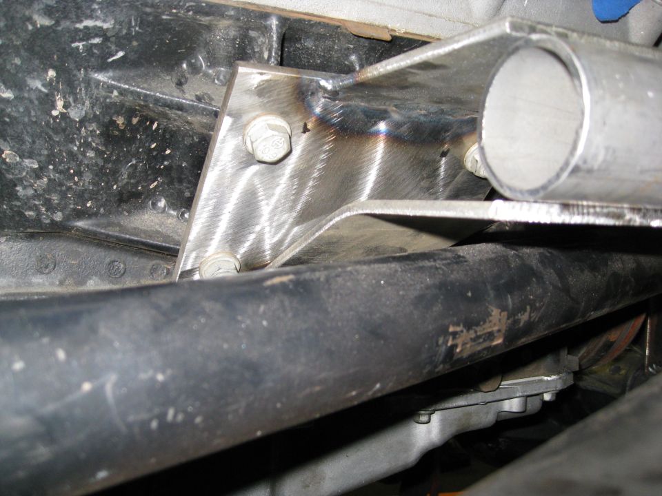 Custom metal bracket welded to frame with bolts