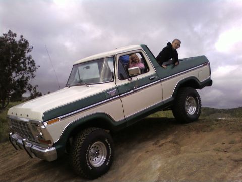 1978 Ford Bronco - This two-tone 1978 Ford Bronco is shown off-road with children enjoying the ride.