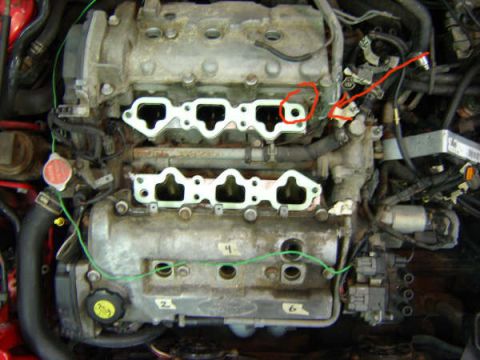 1993 Ford Probe - Close-up view of an engine's intake manifold area with the manifold removed, revealing the gasket surfaces.
