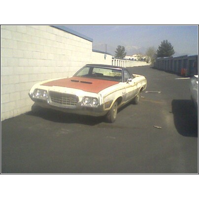 1972 Ford Ranchero - This 1972 Ford Ranchero is seen in a three-quarter front view, parked next to a white brick wall.