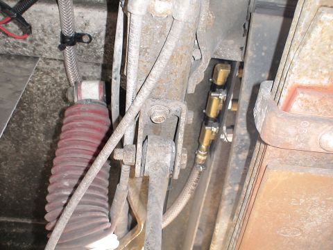 1993 Ford C-350 (Centurion Conversions) - Undercarriage view of air suspension components, including a shock absorber and pneumatic lines.