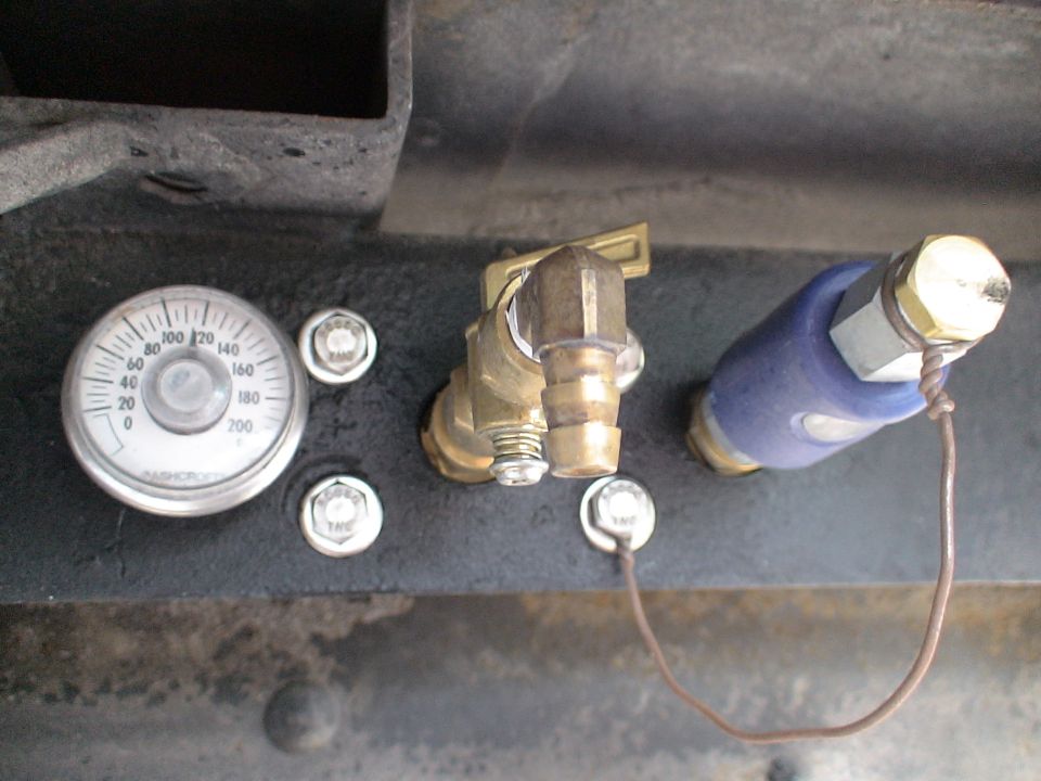 Ashcroft pressure gauge, brass valve and blue fitting on a black frame rail