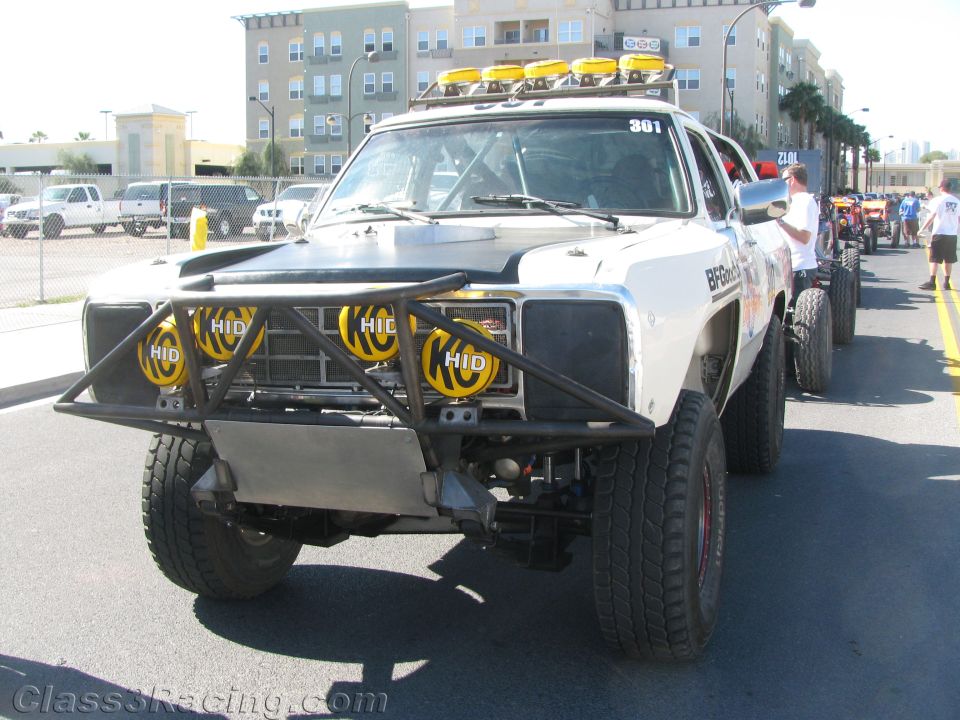 White race truck number 361 with yellow HID lights and tube bumper on street