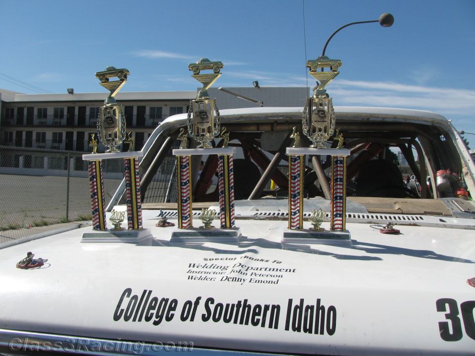Three trophies on the hood of a College of Southern Idaho race vehicle