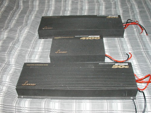 Three black Lanzar Optidrive car amplifiers with red and black power wires