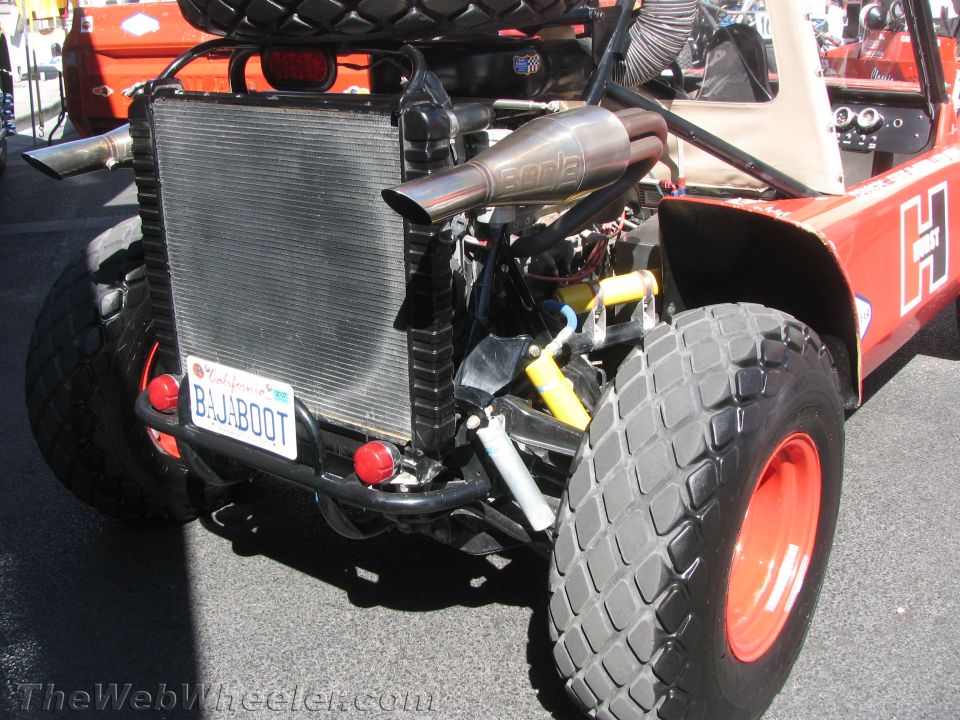 Rear of off-road buggy with BAJABOOT plate, radiator and Borla exhaust