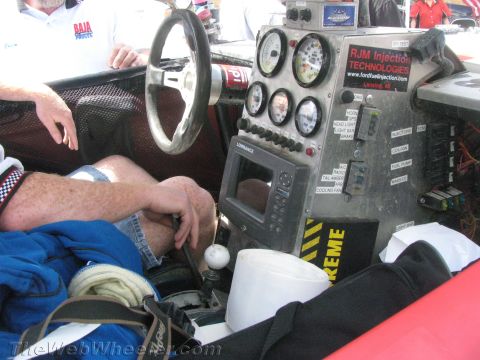 1990 Ford Bronco - race truck cockpit showing a steering wheel, gauge cluster, white shifter knob and an RJM Injection Technologies labeled panel.