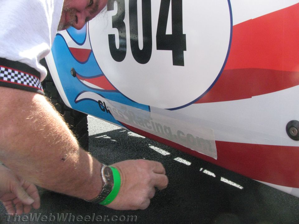 Close-up of white race truck body panel with number 304 and red-blue graphics
