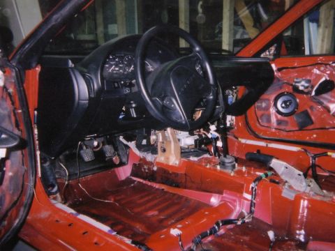1993 Ford Probe - Interior view of a 1993 Ford Probe during a build or repair process, showing disassembled door panels and exposed wiring.