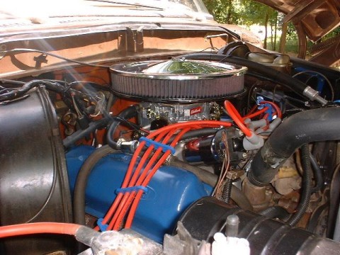 1978 Ford Bronco - Close-up of an engine bay with visible aftermarket parts and wiring.