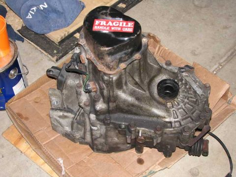 1993 Ford Probe - A used car transmission is shown with a fragile sticker and some surrounding items.