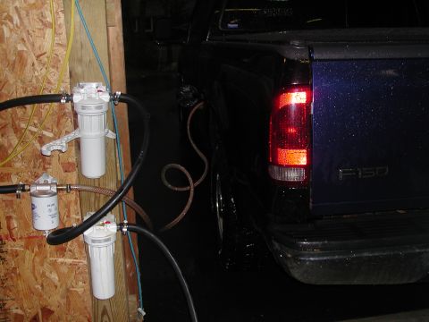 1999 Ford F-250 - Ford F-150 rear view showing fuel filler hose connected to an external filtration setup.