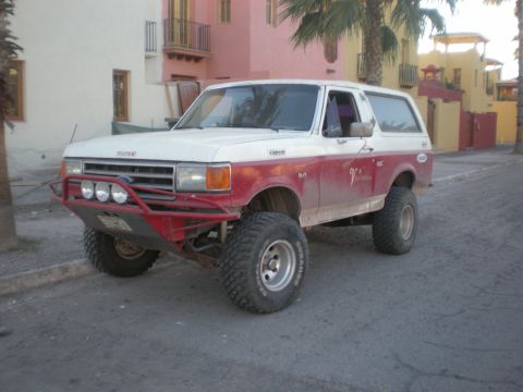 1993 Ford Bronco - This modified Ford Bronco has a two-tone paint scheme and aftermarket off-road modifications.