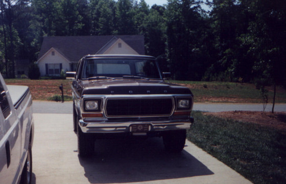 Front view of a dark brown 1978 Ford Bronco with a chrome grille