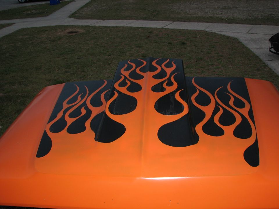 Overhead view of black tribal flames painted over an orange hood and cowl scoop