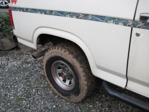 1980 Ford Bronco - This SUV features a camouflage stripe along its side and a '4x4' decal on the rear panel.
