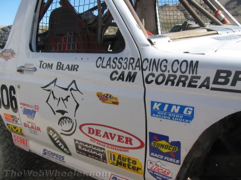 1990 Ford Bronco - Side door of a white off-road race truck covered in sponsor decals including Tom Blair, Cam Correa, Class3Racing.com, Deaver and King.