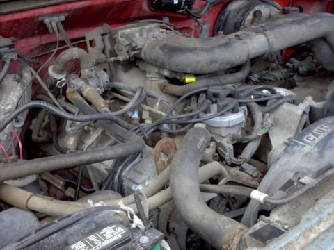1989 Ford F-350 - Close-up view of a vehicle's engine bay, showing various components and wiring.