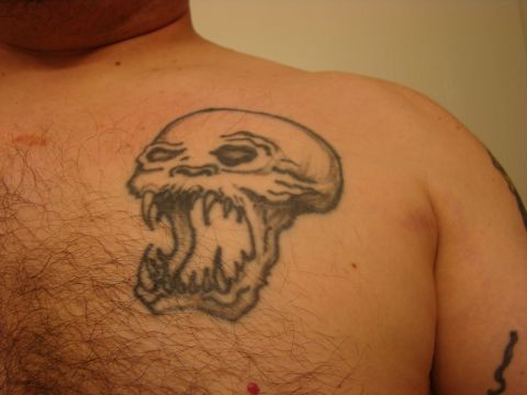 1989 Ford Bronco - A tattoo of a skull with fangs is visible on a person's chest.