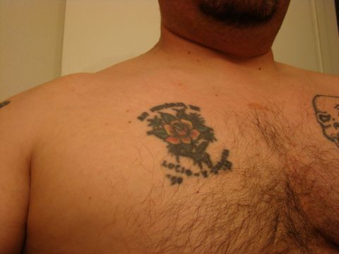 1989 Ford Bronco - A chest tattoo features a rose with the text 'Lucio-V '99' and other lettering above it.