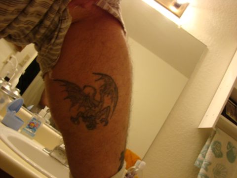 1989 Ford Bronco - A close-up view of a dragon tattoo on a person's leg, with a bathroom sink visible.